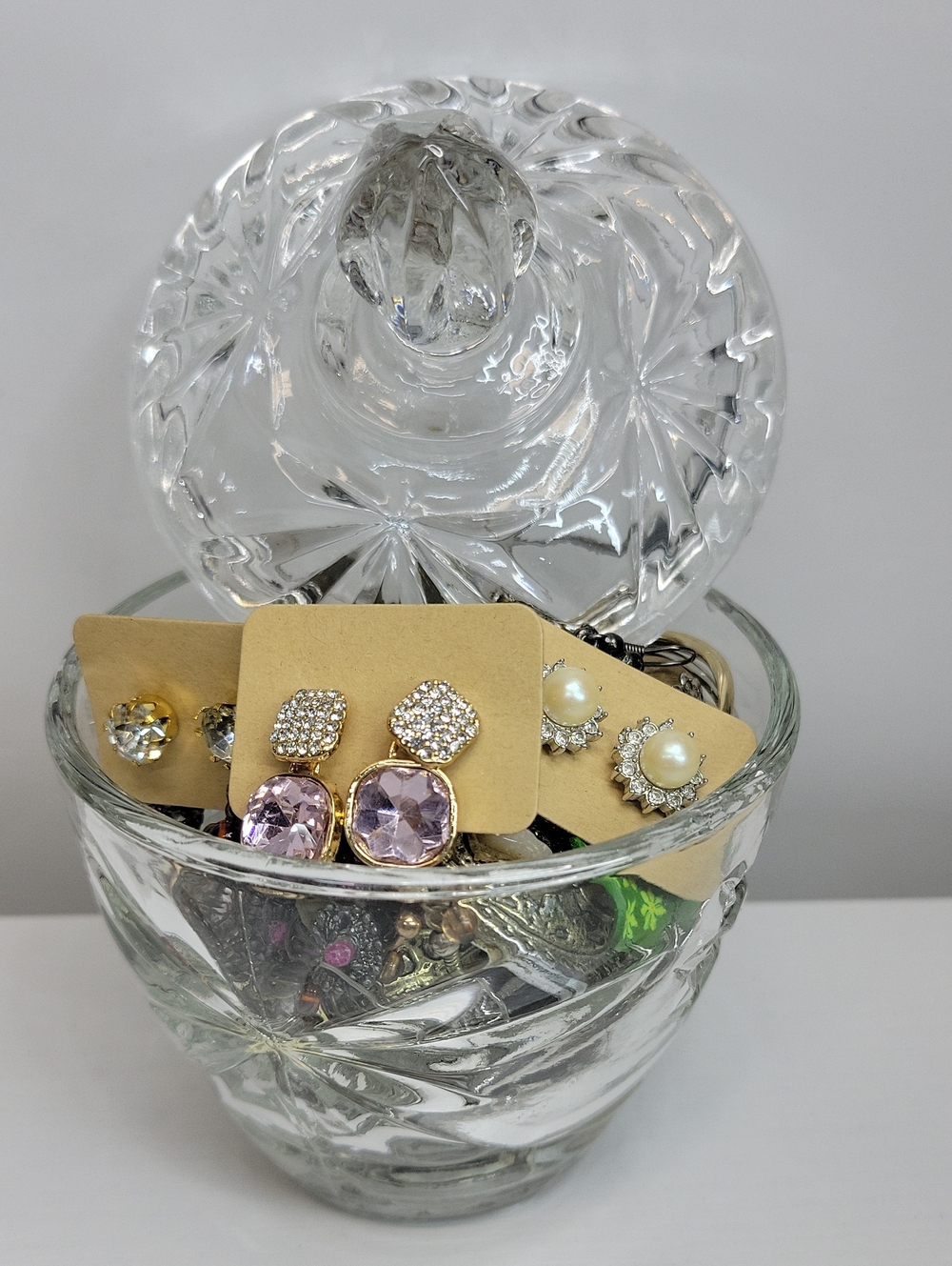 Assorted Earrings In A Glass Dish